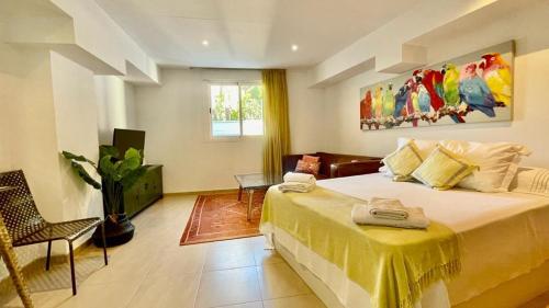 a bedroom with a large bed with a yellow blanket at Beach Panorama in Marbella