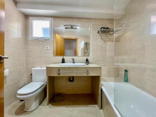 a bathroom with a sink and a toilet and a tub at Beach Panorama in Marbella