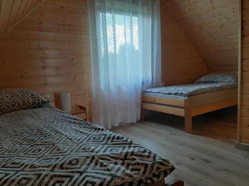 Postel nebo postele na pokoji v ubytování Czarcie Chatki