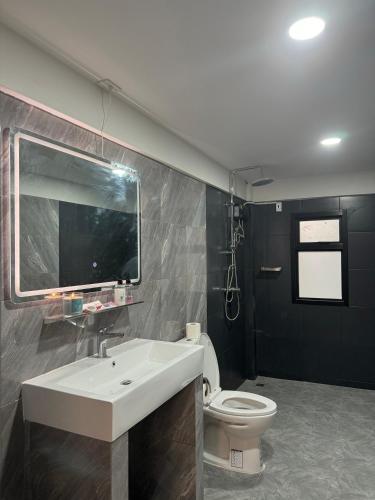 a bathroom with a sink and a toilet at Berlin Haus in Nonthaburi