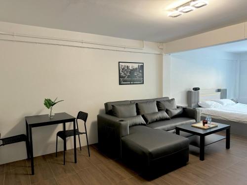 a living room with a couch and a bed at Berlin Haus in Nonthaburi