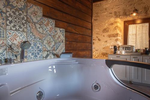 a bath tub in a bathroom with wooden walls at Arpinum Divinum luxury loft in Arpino