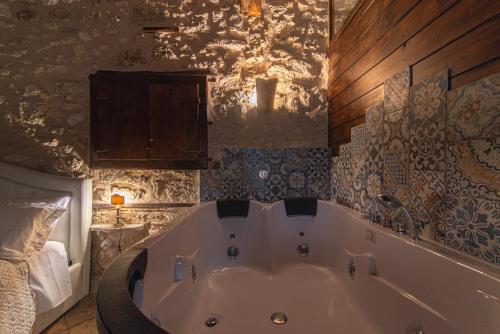 a large bath tub in a bathroom with a bed at Arpinum Divinum luxury loft in Arpino