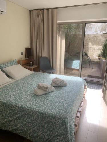 a bedroom with a bed with two towels on it at Casa da Nau in Vila do Conde