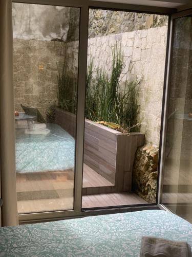 a view of a swimming pool through a window at Casa da Nau in Vila do Conde