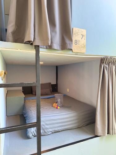 a bunk bed with a toy on the bottom bunk at The Jungle Hostel Canggu in Canggu