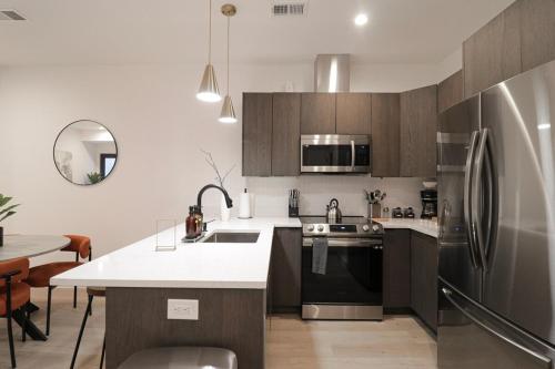 a kitchen with a stainless steel refrigerator and a table at Unit 3 1Bed Room with Queen plus Sofa Bed in the Heart of DC in Washington, D.C.