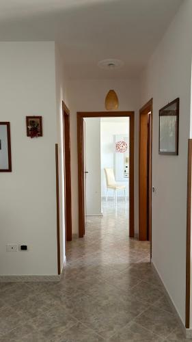 an empty room with a hallway with a table at L'Alba in Tropea