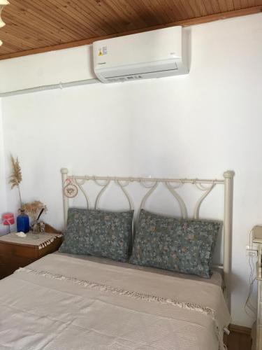 a bedroom with a white bed with pillows at Koralia Summer House in Lióta