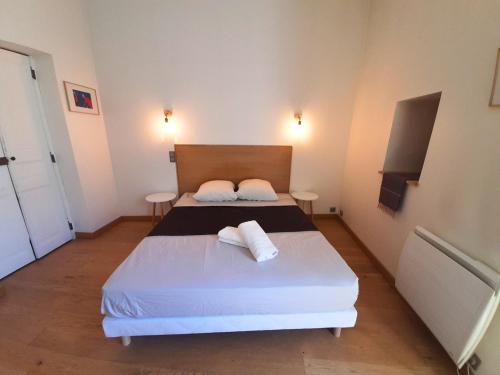 une chambre avec un lit avec deux serviettes dessus dans l'établissement L'Oasis Lumière - T3 central, fibre, TV connectée, à Montpellier