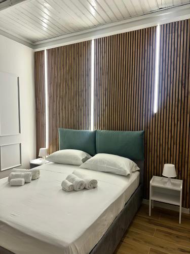 a bedroom with a large bed with towels on it at Portobello In Centro in Salerno