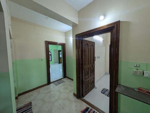 a room with a mirror and a door in it at Elite rooms in Tiruvannāmalai