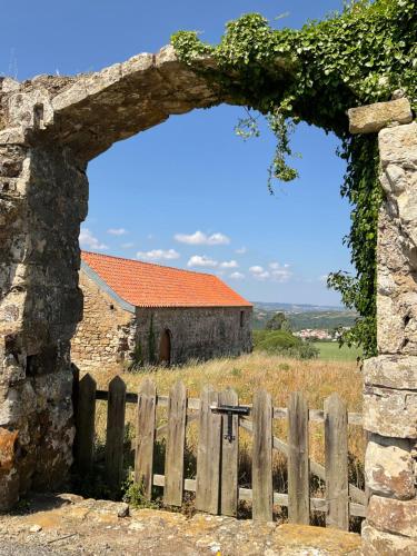 an entrance to an old building with a wooden fence at Luxury Farmhouse with Swimming Pool, By TimeCooler in Sobral de Monte Agraço