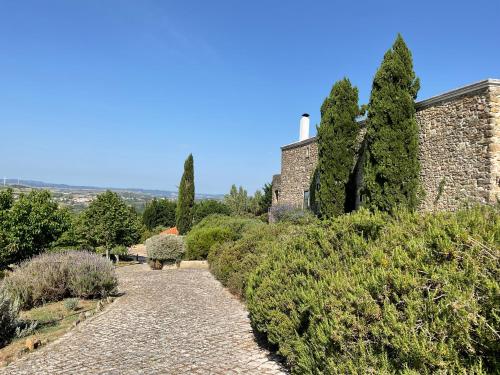 a stone path in front of a building with trees at Luxury Farmhouse with Swimming Pool, By TimeCooler in Sobral de Monte Agraço