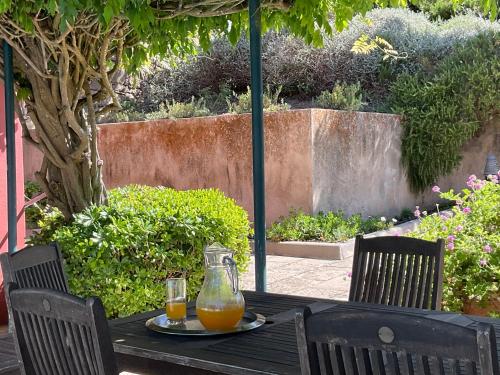 a table with two glasses of orange juice on it at Luxury Farmhouse with Swimming Pool, By TimeCooler in Sobral de Monte Agraço