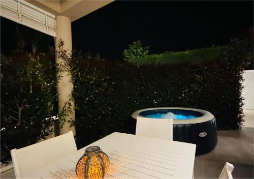 a table with a candle on a patio at night at La Collina di Montegrappa - Suites with Heated Private Pool - Suites with Shared Pool in Tuglie
