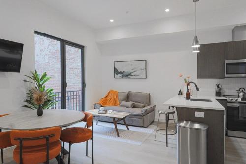 a kitchen and living room with a couch and a table at Unit 4 Studio Queen plus Sofa Bed DC Convention Centre in Washington, D.C.