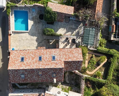 an aerial view of a house with a swimming pool at Villa Mara Lustica Bay Retreat near Kotor, Tivat in Tivat