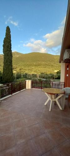 a bench on a patio with a view of a hill at Nightflower rooms sami in Sami