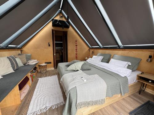 a bedroom with two beds in a room at CAMPY ECO HOUSE • EGER in Egerszólát