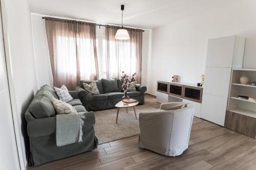 a living room with a couch and a chair at Casa Gaia - Villetta a pochi passi da Roma in Ciampino