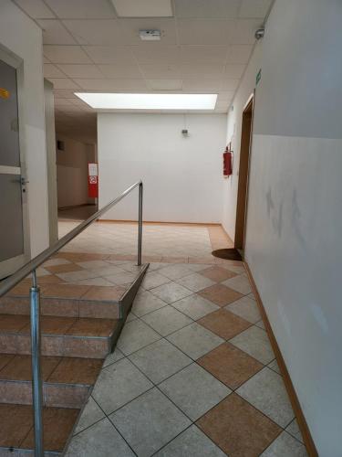 a hallway with stairs and a white wall at Apartma Lucija in Lucija