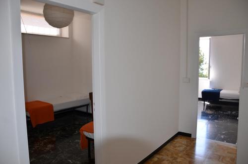 an empty room with a bed and a window at Appartamento SZ Fronte mare - Seafront apartment in Albisola Superiore