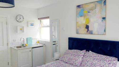 a bedroom with a bed and a sink and a clock at The Lodge in Killarney