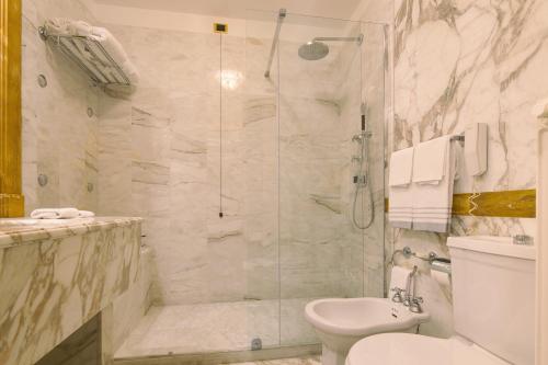 a bathroom with a shower and a toilet at Imperiale Palace Hotel in Santa Margherita Ligure