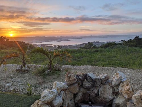 a pile of rocks in front of a sunset at 8POINT RESORT Okinawa in Nanjo