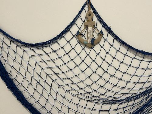a blue and white net purse hanging on a wall at SteLo Casa Vacanze in Palermo