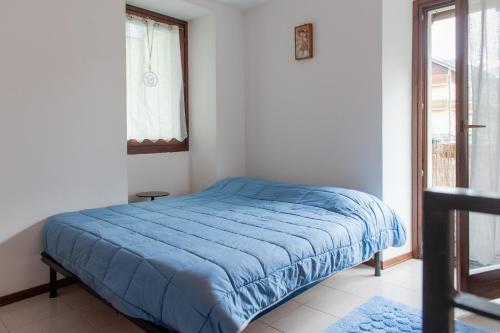 Ένα ή περισσότερα κρεβάτια σε δωμάτιο στο Casa La Lanterna nelle Alpi Orobiche