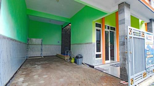 an empty room with green and colorful walls at Villa Panderman Asri with Private Pool and Rooftop in Tlekung