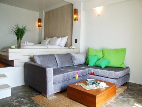 a living room with a couch and a bed at Bari Lamai Resort in Ban Phe