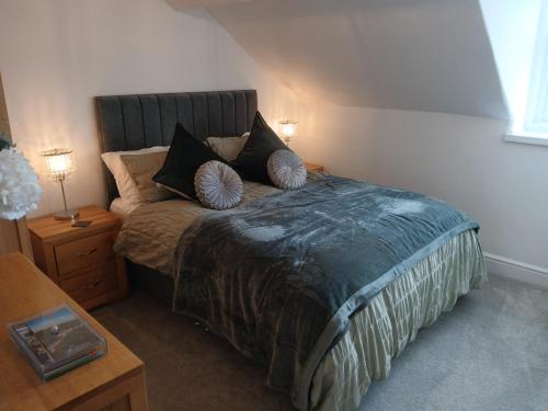 a bedroom with a large bed with pillows on it at Seashell Apartment in Barmouth