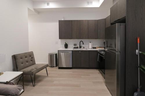 a kitchen with a couch and a chair in it at Unit 5 Cozy 1 Bed Room with Queen Bed plus Sofa Pullout in Washington, D.C.