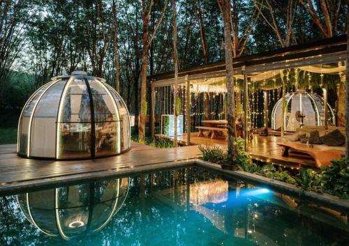 an igloo house with a pool in front of it at Timber Society Boutique Hideaway in Phuket Town