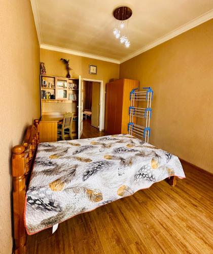 a bedroom with a bed with a comforter on it at City Center in Ulaanbaatar