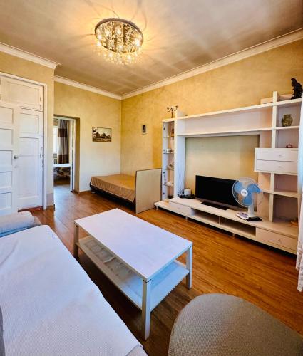 a living room with a bed and a couch and a table at City Center in Ulaanbaatar