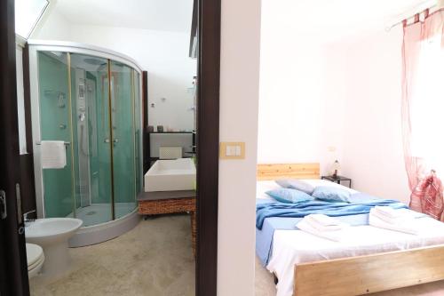 a bedroom with a bed and a bathroom with a shower at Casa Marika in Otranto in Otranto