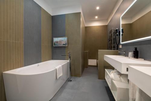 a bathroom with two sinks and a bath tub at 69 Suite Boutique in Rome