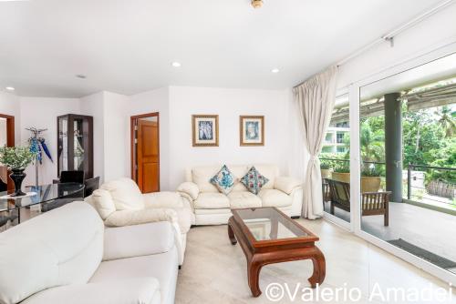 a living room with two white couches and a table at KB Apartments Karon Beach by PHR in Karon Beach