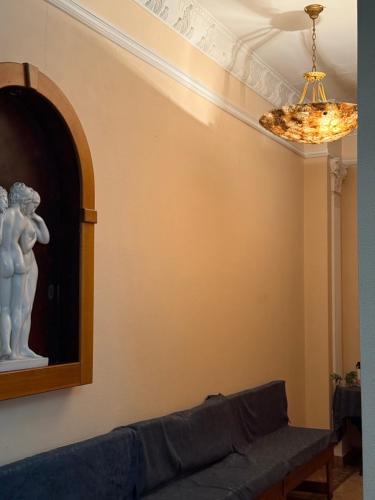 a living room with a couch and a chandelier at Отель Ренессанс in Dnipro