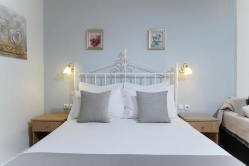 a bed with white sheets and pillows in a bedroom at Althea in Skala Potamias