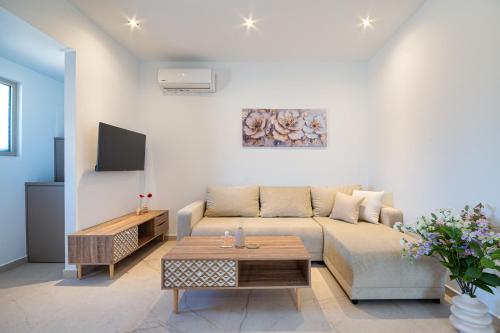 a living room with a couch and a table at The Azure Suites in Haraki