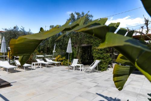 a group of chairs and umbrellas on a patio at Residence O'Sole Mio Pompei in Pompei