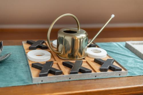 a metal tea pot sitting on top of a table at La Casa Bonita in Bad Aibling