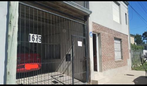 a garage with a gate in front of a building at El depto de Esther 2 in Tandil