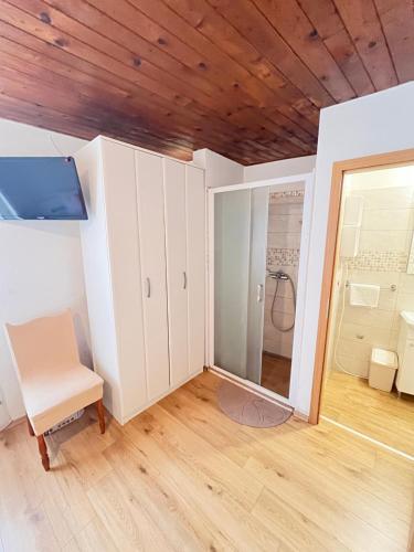 a room with white cabinets and a chair at Lavanda Apartment in Stari Grad