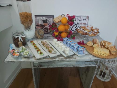 a table with a buffet of food on it at Reusuite in Ragusa
